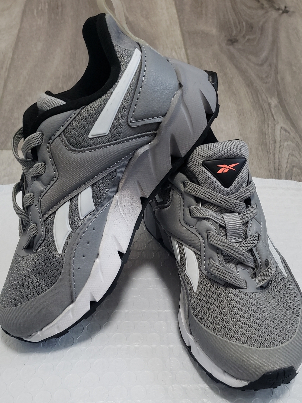 Reebok Kids Grey and White Athletic Sneakers with Coral Logo Accent